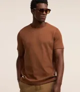 Remera blanca de media malla con cuello redondo, manga corta y textura vertical.