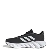 Championes Adidas Switch Run, color negro con detalles plateados y suela blanca. Presentan las tres tiras características de la marca en los laterales.