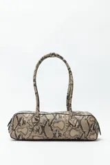 Cartera baguette color marrón claro, confeccionada en símil cuero con formato cilíndrico y doble asa corta.