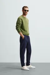 Pantalón largo de vestir gris claro con estampado de cuadros, corte slim fit y cintura elástica. Confeccionado en tejido con alta elasticidad, bolsillos frontales y cierre frontal con cremallera y botón.