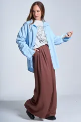 Sobrecamisa negra de gabardina con cuello camisero, cierre frontal con botones, mangas largas con puños abotonados y bolsillos de parche en el pecho.