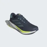Championes de running Adidas Supernova Stride 2 en color azul marino con detalles en celeste y verde neón. Presentan un exterior de malla textil y sintética para mayor transpirabilidad, mediasuela Dreamstrike+ que ofrece una amortiguación dinámica y suela Adiwear para un agarre duradero.