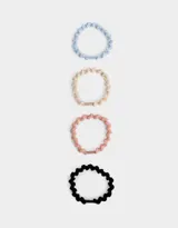 Set de cuatro gomitas de pelo elásticas con textura trenzada en colores celeste, beige, rosa y negro.