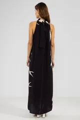 Vestido largo negro con estampado de sirenas color crema, cuello halter y corte evasé.