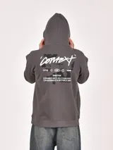 Buzo canguro negro con capucha, manga larga y bolsillo canguro frontal. Presenta un estampado blanco en el pecho con un logo circular y el texto "VISIONS OF A PARADOX MCMXXXVII".