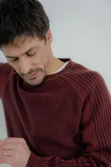 Sweater azul marino de hombre con cuello redondo y puños acanalados en color marrón.
