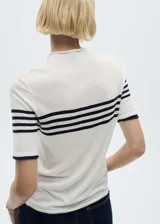 Jersey de punto fino color blanco con rayas horizontales negras, cuello redondo y mangas cortas.