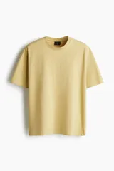 Remera color mostaza de corte holgado, cuello redondo y manga corta.