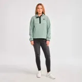 Buzo polar verde agua para mujer, con cierre de tres botones en el cuello y logo de CAT en el pecho.