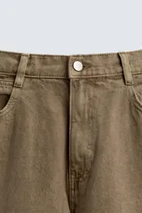 Pantalón cargo relaxed fit confeccionado en denim color marrón. Cuenta con bolsillos frontales, traseros de plastrón y multifunción en perneras. Tiene efecto lavado, bajo ajustable con trabilla y cierre frontal con cremallera y botón.