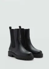 Botines Chelsea negros de efecto piel con suela track, paneles laterales elásticos y punta redonda.