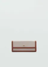 Billetera rectangular grande color beige con efecto rafia y ribetes marrones en contraste. Tiene cierre de solapa con botón a presión, bolsillo interior con cremallera y logo en relieve.