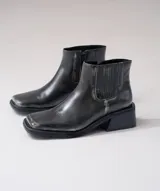 Bota corta negra de cuero con elástico lateral, caña de 12 cm y taco de madera de 4 cm.