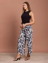 Pantalón largo de lino estampado en blanco y negro, con pretina ancha elastizada tipo smock, pierna ancha y ruedo con tajo.