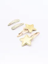Set de cuatro hebillas para el pelo: dos doradas con forma de estrella y dos plateadas con glitter.