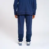 Pantalón de jogging color bordó con detalles en líneas blancas y logo del Club Nacional de Football.