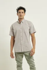 Camisa manga corta color gris claro con textura, cuello abotonado y bolsillo en el pecho.
