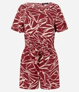 Enterito corto de poliéster con estampado abstracto en tonos borgoña y blanco. Tiene mangas cortas, escote redondo, cierre en la espalda, elástico en la cintura y lazo para ajustar.