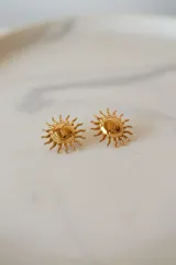 Aros dorados con forma de sol con textura.