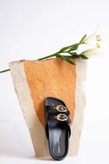 Sandalias negras con dos tiras anchas sobre el empeine, hebillas doradas ajustables y plantilla anatómica.