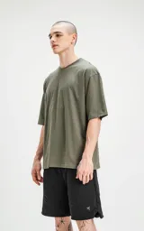 Remera verde militar de corte crop y calce oversize, con hombros caídos y cuello redondo.