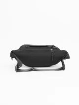 Riñonera negra con múltiples bolsillos con cierre y correa ajustable con hebilla.