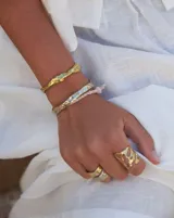 Anillo dorado con diseño abstracto con aberturas.