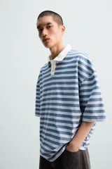 Polo de hombre a rayas horizontales azules y blancas, con cuello clásico blanco y corte relaxed fit.