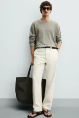 Jersey color verde claro de punto tejido en hilatura ligera de lino, corte relaxed fit, cuello redondo y manga larga con terminaciones en rib.