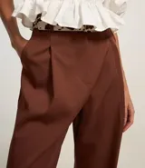 Pantalón pantalona de sastrería color marrón, con pliegues delanteros, cintura con trabillas y corte amplio.