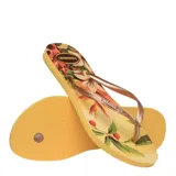 Sandalias Havaianas Slim Tropical amarillas con estampado de flores y tiras finas color bronce.