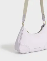 Bandolera color beige con correa blanca regulable y desmontable, tag frontal en relieve y cierre superior.
