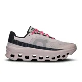 Championes de running On Cloudmonster, color lila con detalles en gris, negro, verde y rosa.