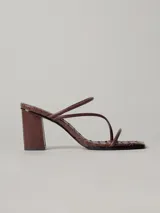 Sandalias de tacón color marrón chocolate con capellada trenzada, punta cuadrada y dos tiras finas sobre el empeine. Tacón cuadrado.