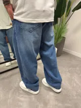 Pantalón de jean celeste, corte amplio tipo baggy.