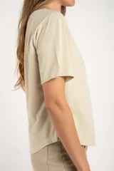 Remera color arena de algodón peinado, corte ajustado y mangas cortas.