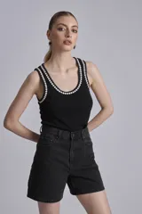 Bermuda de jean color negro, tiro alto y corte recto.