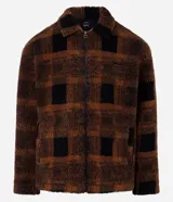 Campera masculina de sherpa color marrón con estampado de cuadros negros, cuello inglés, cierre con cremallera, manga larga y bolsillos.