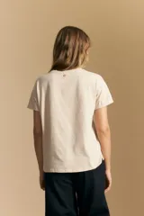 Remera de manga corta color negro con cuello redondo y un aplique bordado de flores y hojas en color beige claro en el centro del pecho.