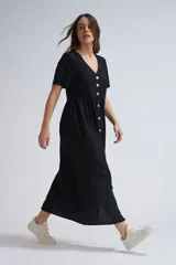 Vestido midi negro de lino con botones blancos, escote en V y mangas cortas.