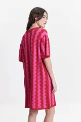 Vestido corto tejido de punto con cuello tipo camisa, botones frontales y diseño a rayas onduladas en tonos azul, verde y blanco.