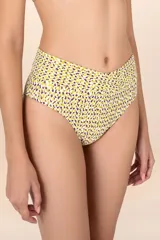 Calzón de bikini blanco con estampado de lunares amarillos y violetas, talle alto y faja cruzada al frente y atrás.