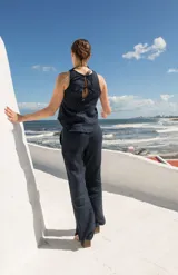 Pantalón de lino azul marino, de tiro medio y corte semi-oxford con tajos en el ruedo.