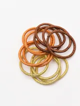 Pack de 12 coleros elásticos de colores rosa, dorado, marrón y bronce con detalles de brillo.