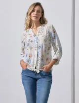 Blusa estampada con cuello a la base, escote en V y botones. Delantera con bolsillo aplicado. Largo de manga regulable con presilla y botón. Terminación anudada opcional.