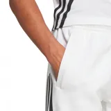 Pantalón largo deportivo Adidas Future Icons 3-Stripes para hombre, color blanco con tres rayas negras en los laterales.