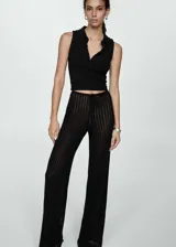 Pantalón negro de tejido de punto calado con cintura elástica y corte recto.