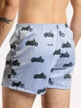 Bóxer de algodón con estampado floral en tonos azul y blanco, con cintura elástica y logo de la marca en el centro.