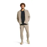 Pantalón de jogging gris de corte ajustado, con cintura elástica ajustable con cordón, bolsillos laterales con cierre y logo de Nike bordado en negro en la pierna izquierda.