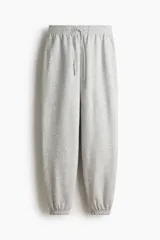 Pantalón de jogging gris melange, de corte holgado, con cintura elástica ajustable con cordón y puños elásticos.